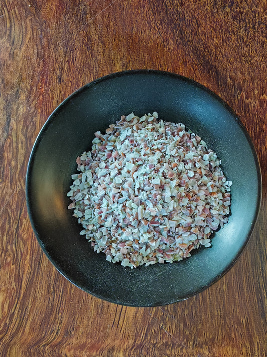Feed-grade scallop particles